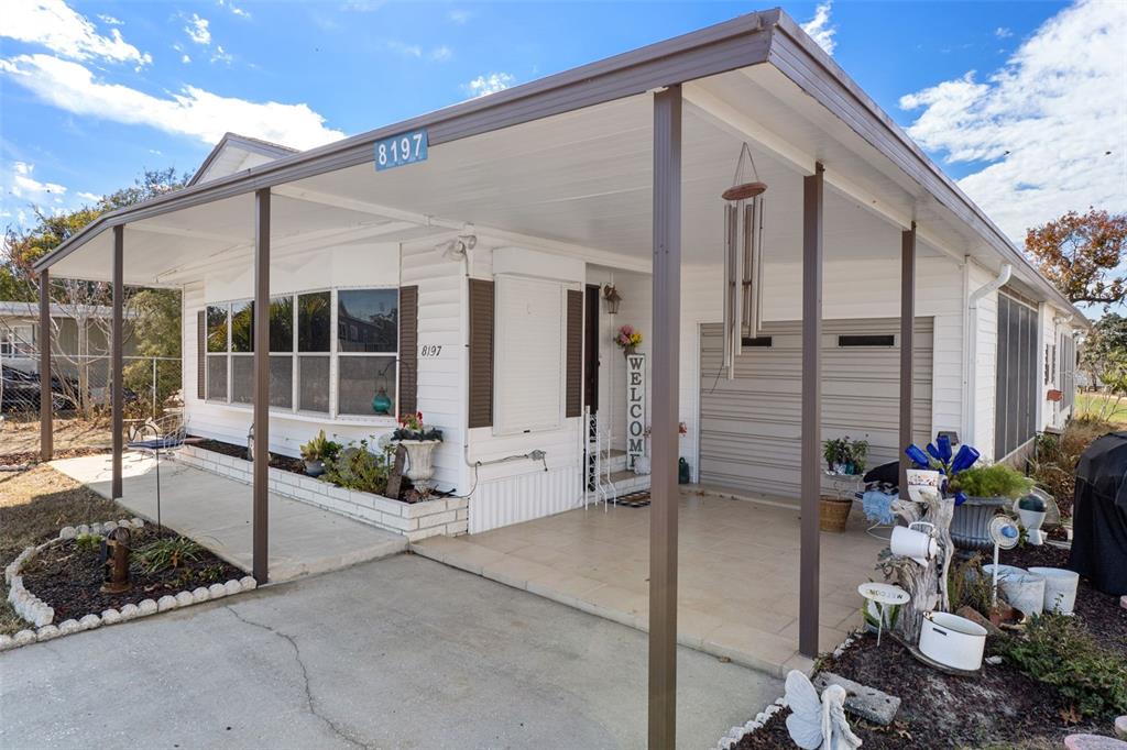 8197 Fiesta Street Brooksville, FL 34613 - Photo 4 of 49 a building outdoor space with patio furniture and potted plants