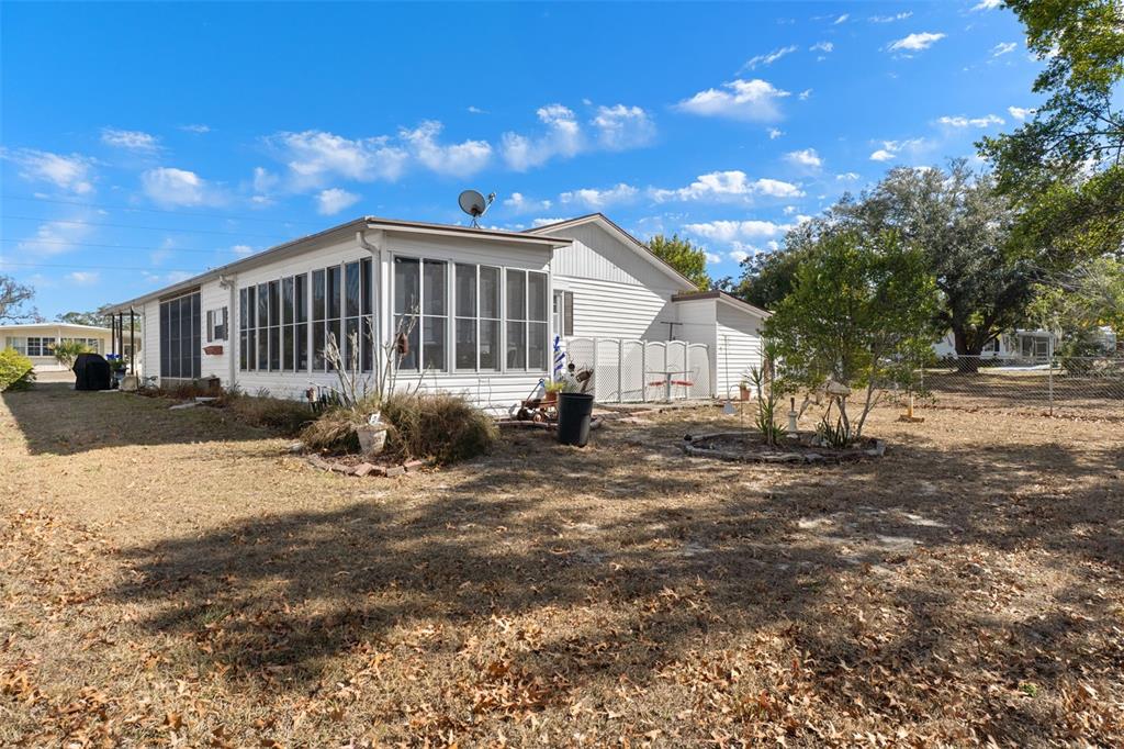 8197 Fiesta Street Brooksville, FL 34613 - Photo 41 of 49 a view of a house with a yard