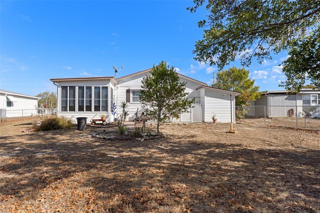 8197 Fiesta Street Brooksville, FL 34613 - Photo 42 of 49 a view of a house with a yard