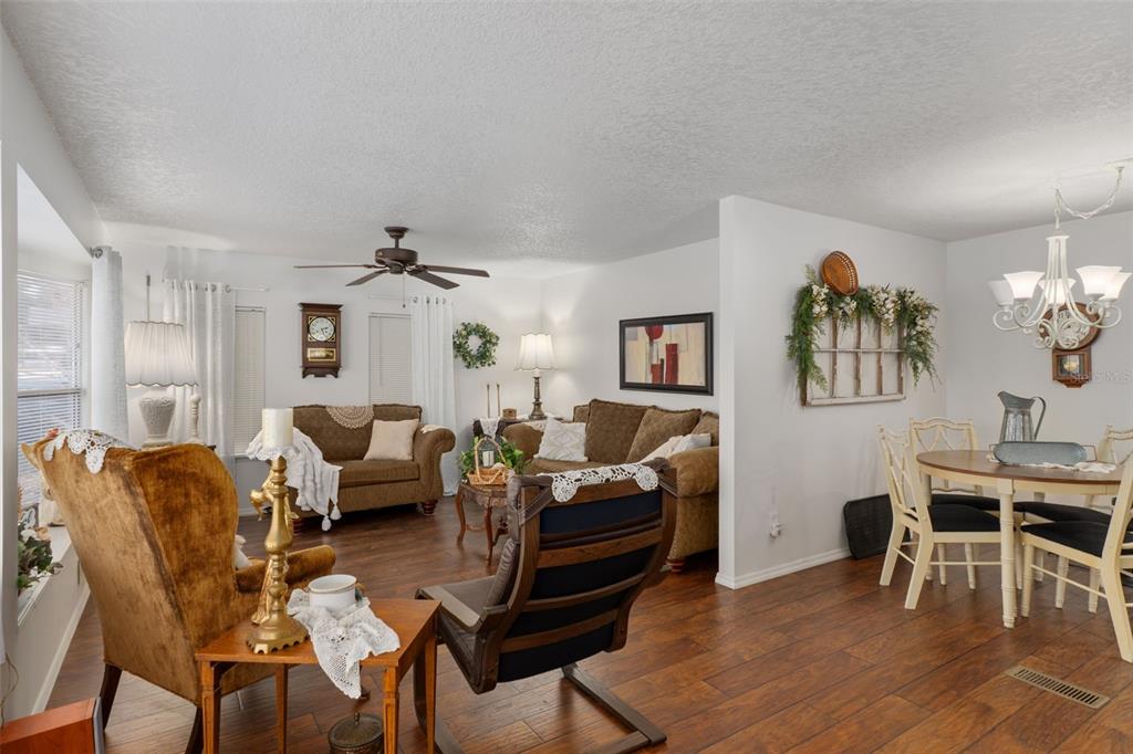 8197 Fiesta Street Brooksville, FL 34613 - Photo 8 of 49 a living room with furniture a desk and chair with wooden floor