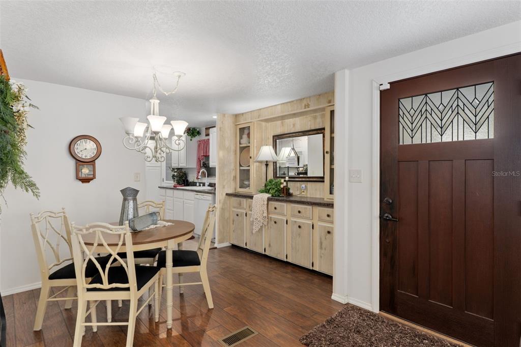 8197 Fiesta Street Brooksville, FL 34613 - Photo 10 of 49 a view of a dining room with furniture and chandelier