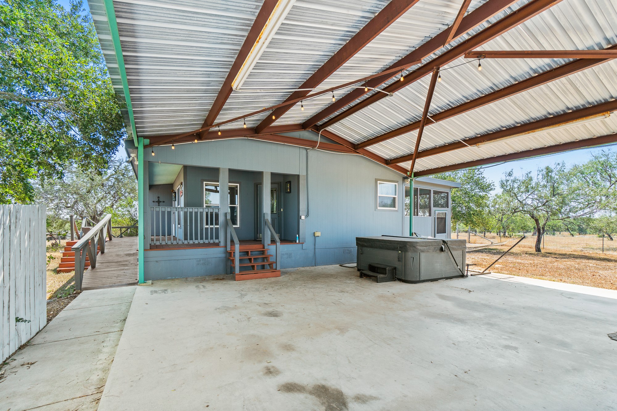 1951 Dowdy Road Seguin, TX 78155 - Photo 25 of 40 An expansive covered concrete patio provides sheltered outdoor living space adjacent to the main home.