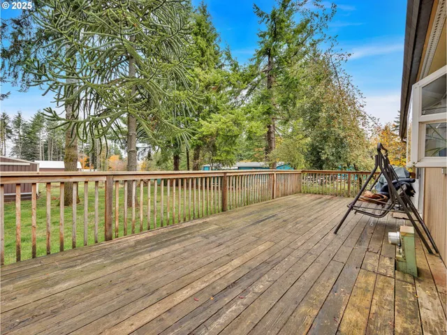 a view of balcony with wooden floor and fence
