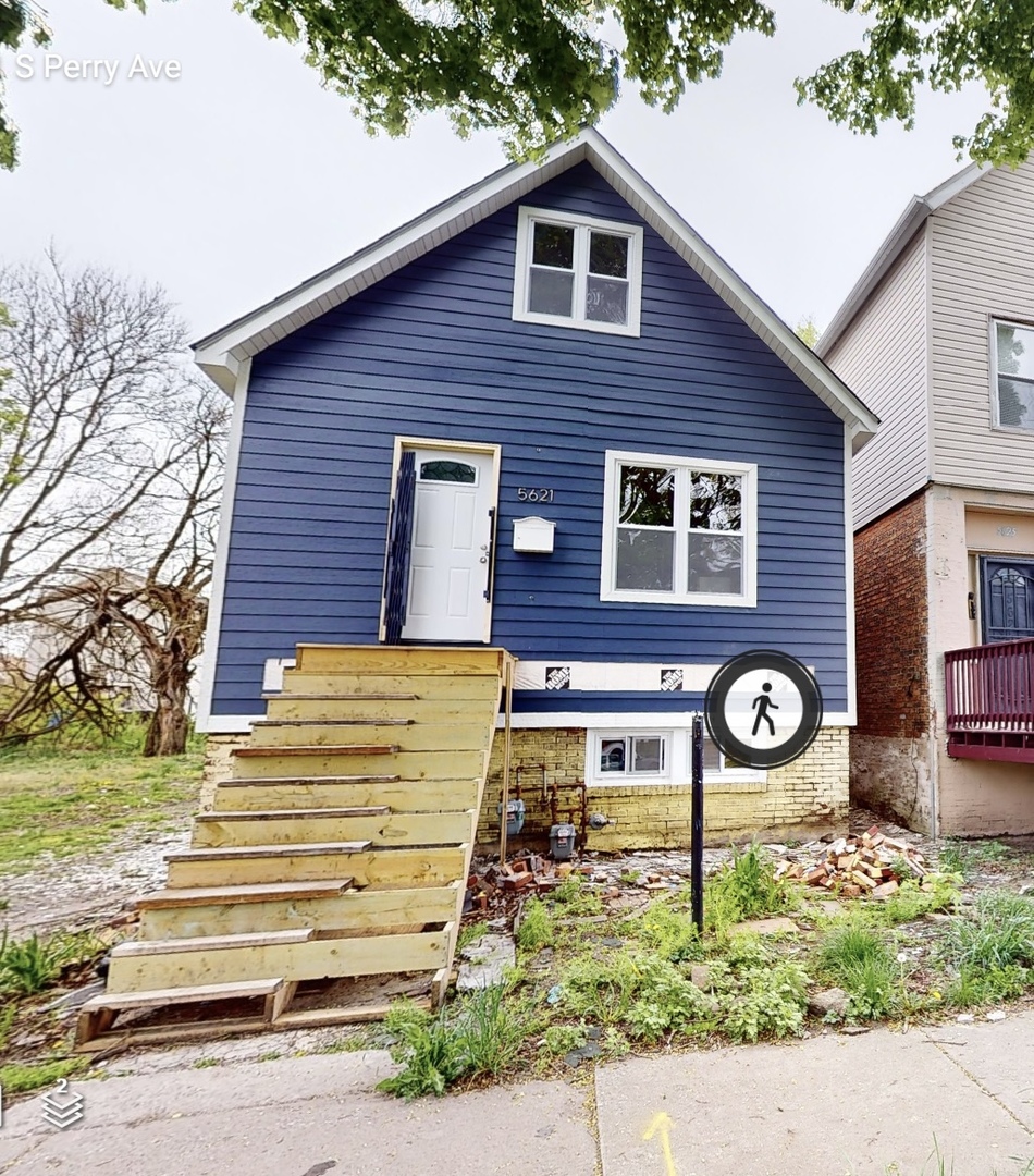 5621 South Perry Avenue Chicago, IL 60621 - Photo 1 of 1 a front view of a house with garden