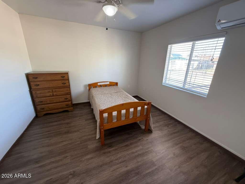 936 East 8th Street, Unit REAR Douglas, AZ 85607 - Photo 5 of 7 a room with a wooden floor and a window