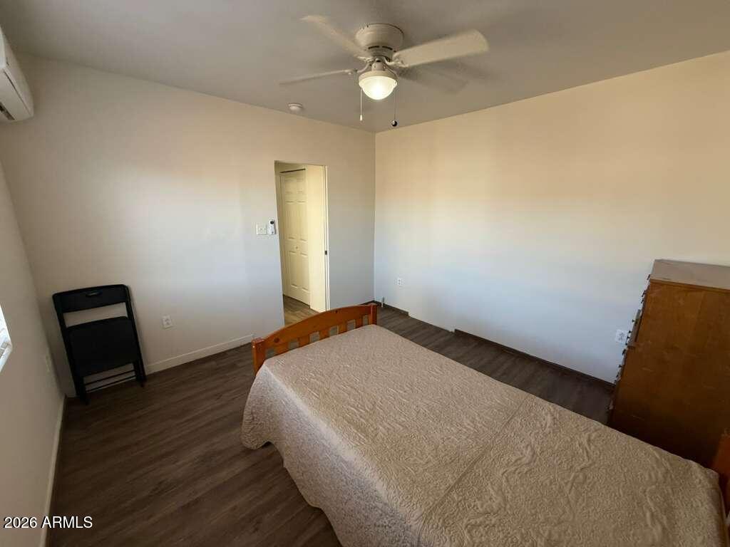936 East 8th Street, Unit REAR Douglas, AZ 85607 - Photo 7 of 7 a bedroom with a bed and a chandelier
