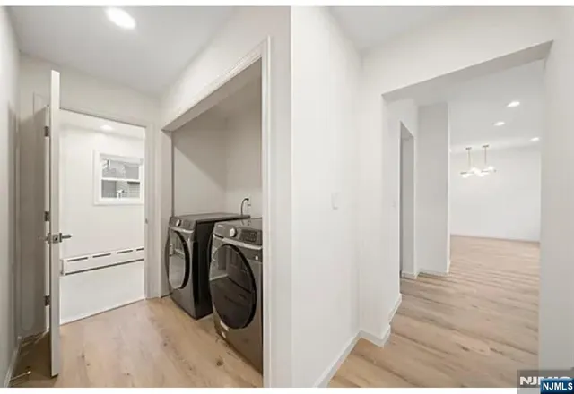 a view of a hallway with a washer and dryer