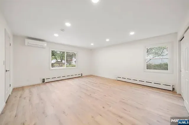 an empty room with windows and dryer