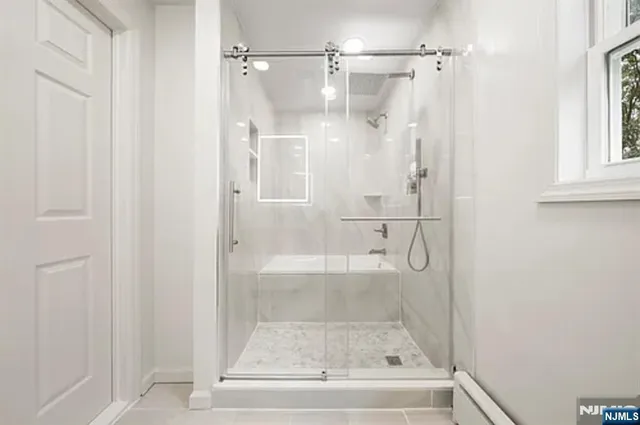 a bathroom with a glass shower door