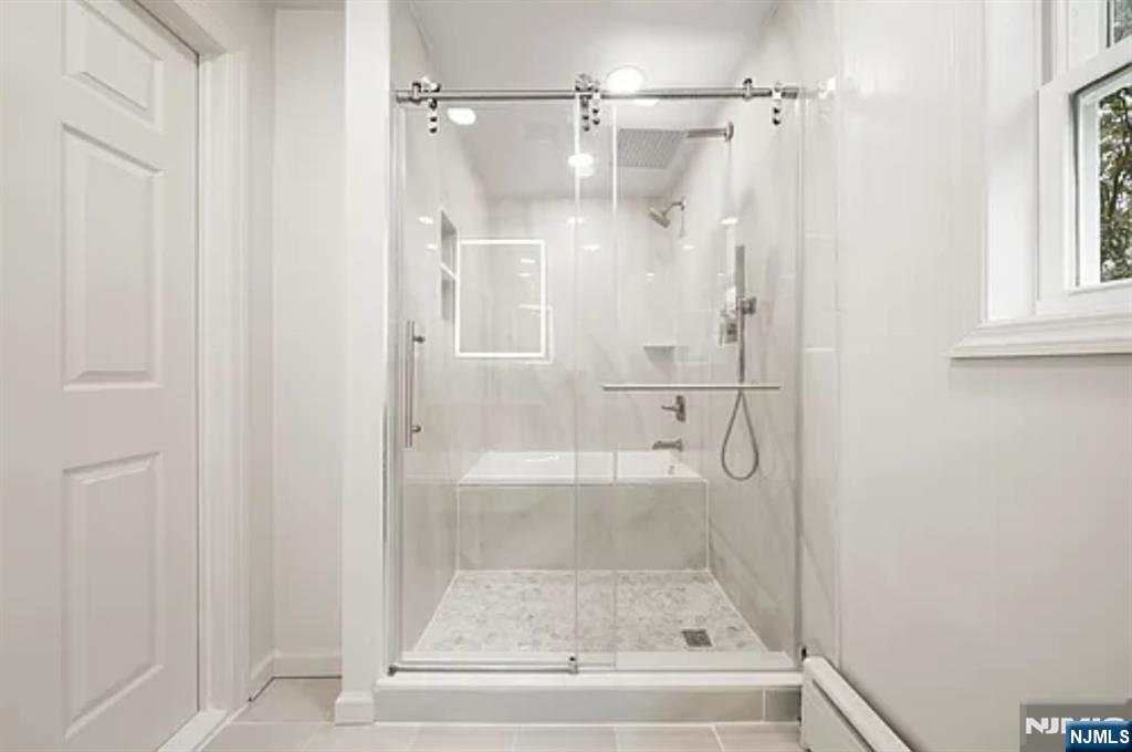 57 Byrne Street, Unit 1 Hackensack, NJ 07601 - Photo 9 of 16 a bathroom with a glass shower door