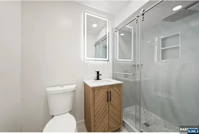 a bathroom with a sink a toilet and shower