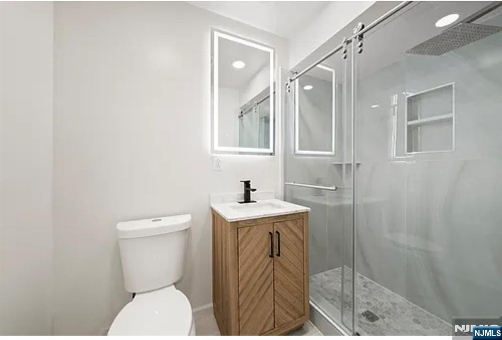 57 Byrne Street, Unit 1 Hackensack, NJ 07601 - Photo 10 of 16 a bathroom with a sink a toilet and shower