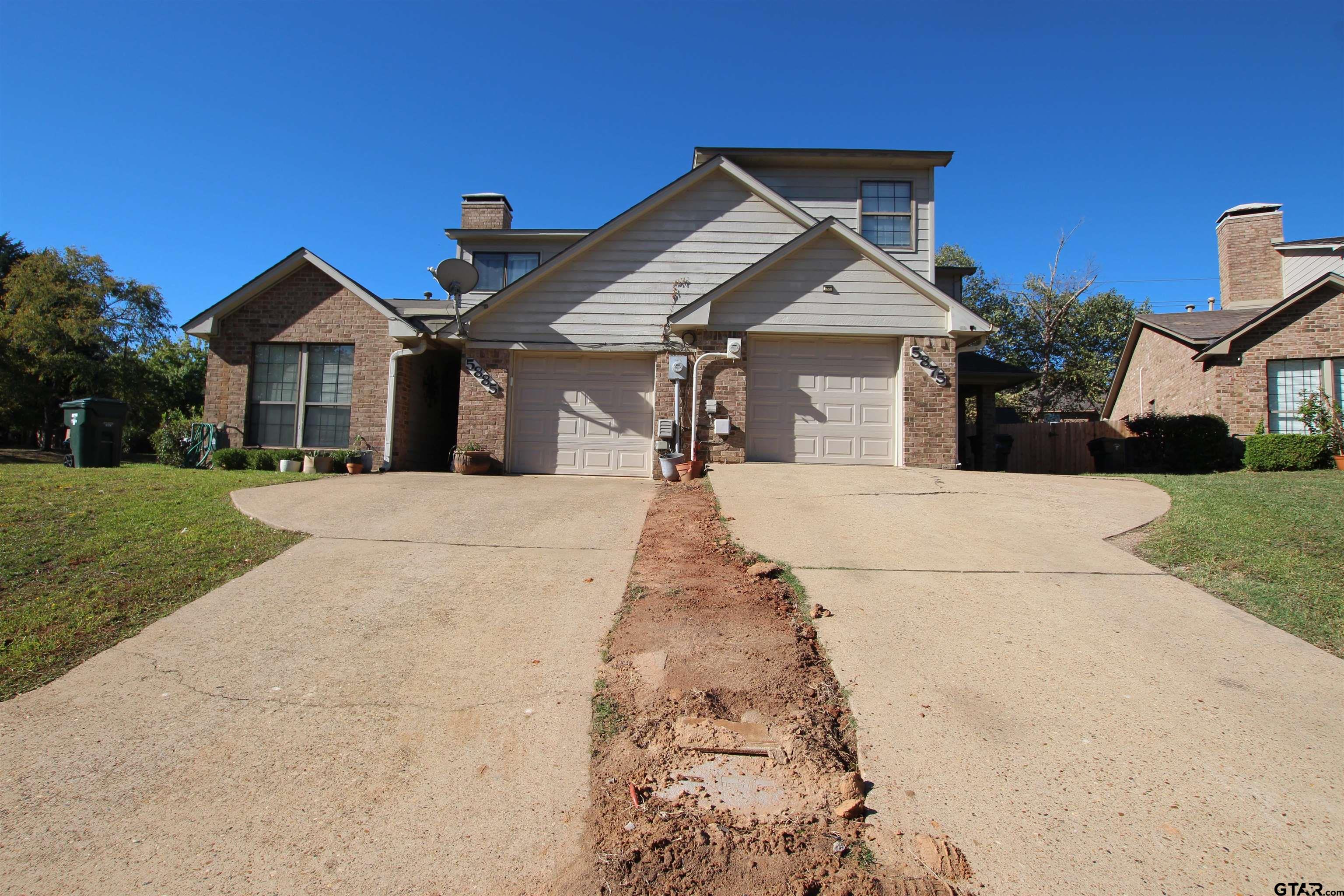 5875 Creekside Circle Tyler, TX 75703 - Photo 2 of 32 a front view of a house with a yard