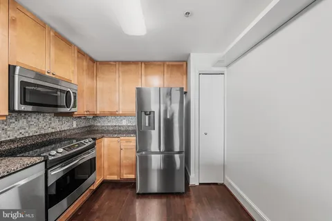 a kitchen with a refrigerator stove and microwave