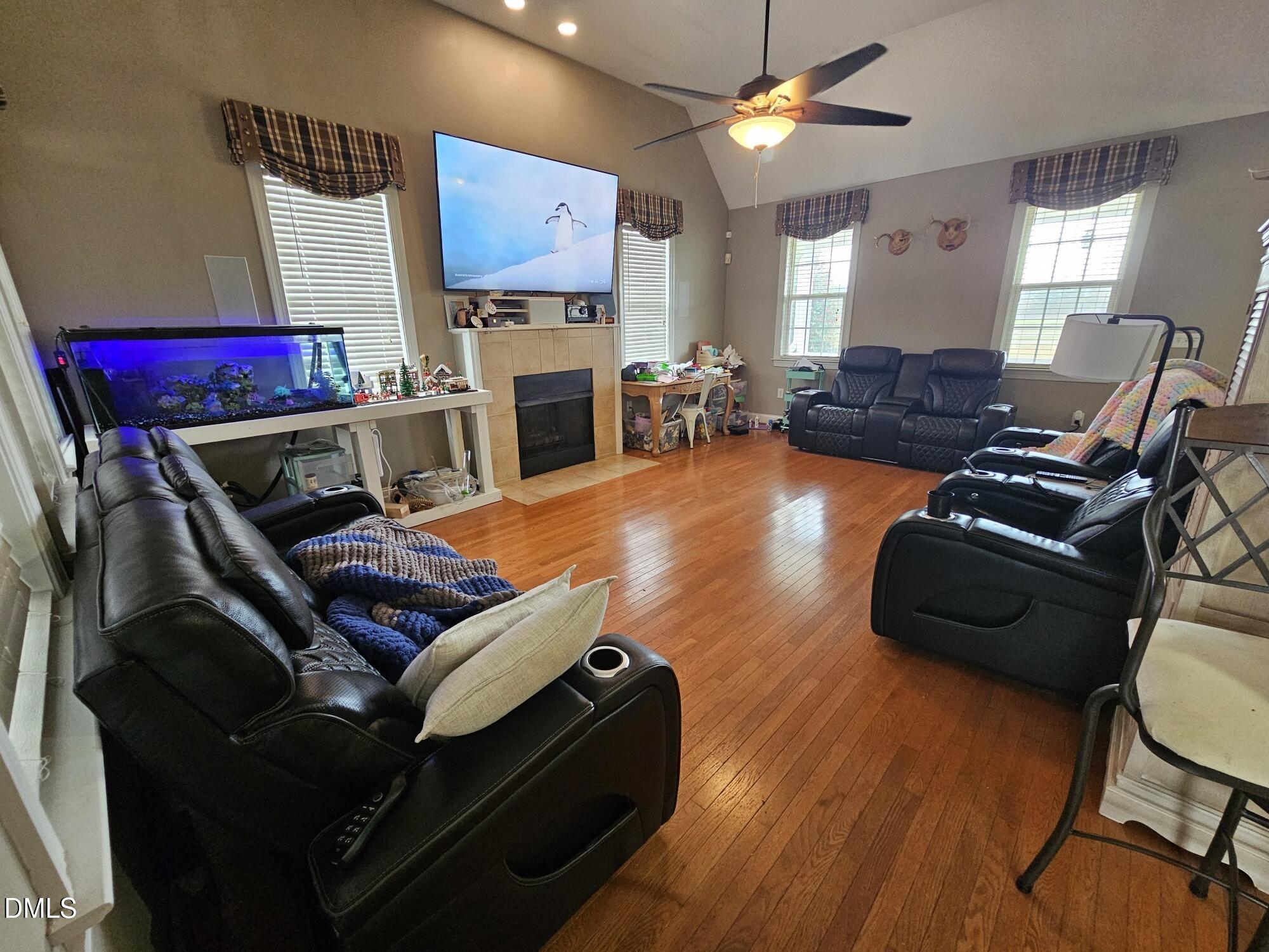 40 Wild Winds Drive Coats, NC 27521 - Photo 11 of 26 a living room with furniture a flat screen tv and a fireplace