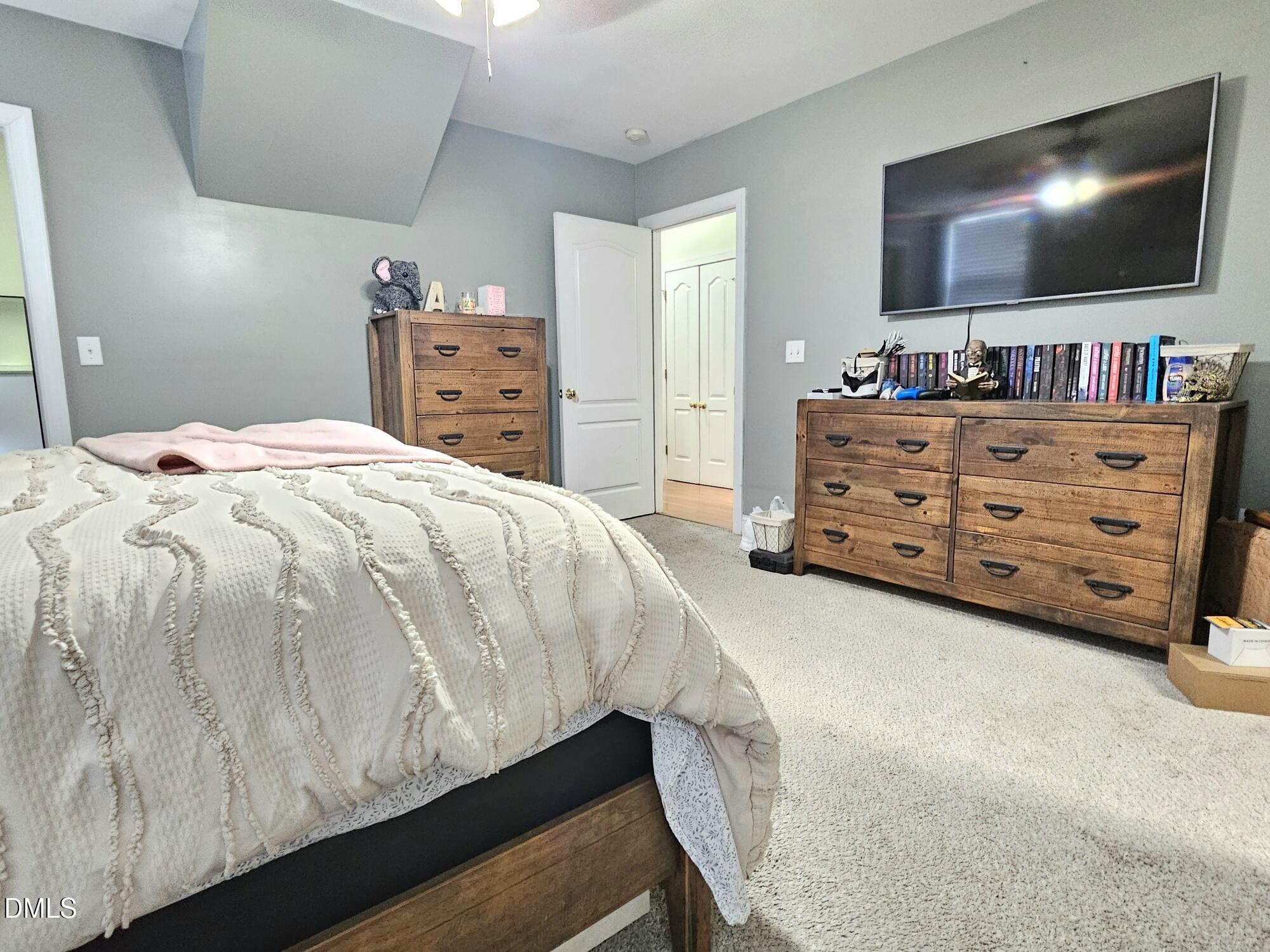 40 Wild Winds Drive Coats, NC 27521 - Photo 12 of 26 a bedroom with a bed and a flat screen tv