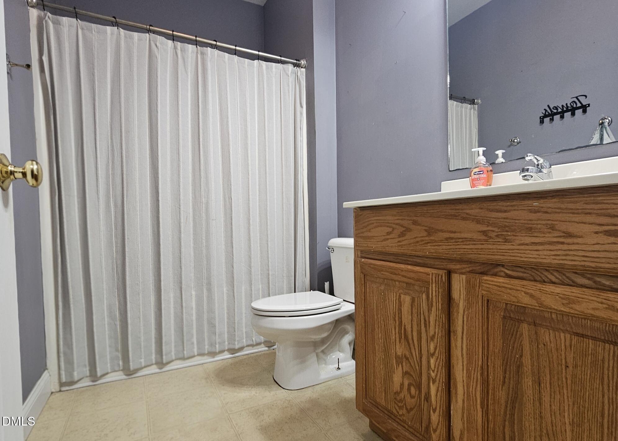 40 Wild Winds Drive Coats, NC 27521 - Photo 14 of 26 a bathroom with a sink a toilet and shower