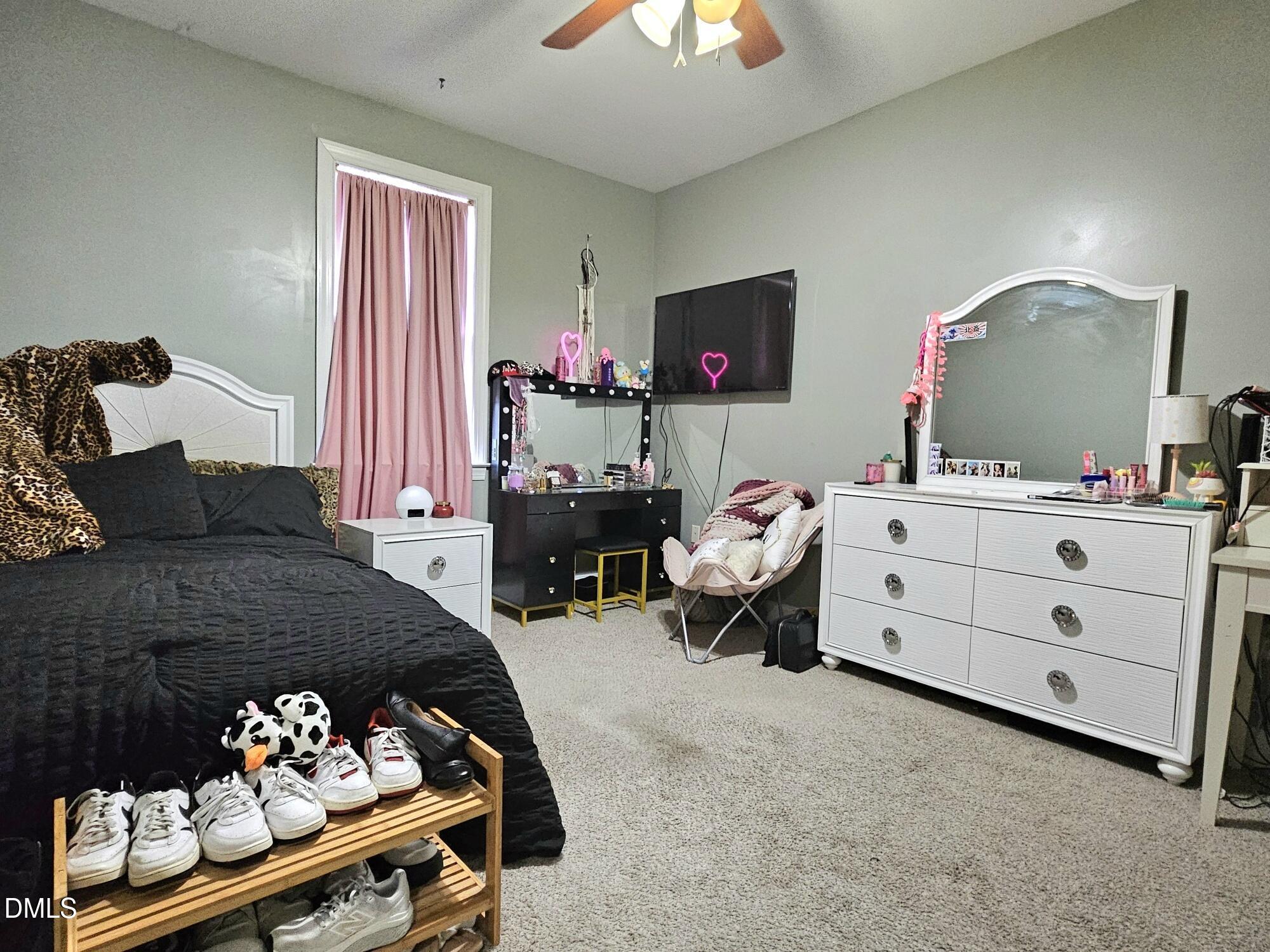 40 Wild Winds Drive Coats, NC 27521 - Photo 16 of 26 a bedroom with a bed and a chandelier