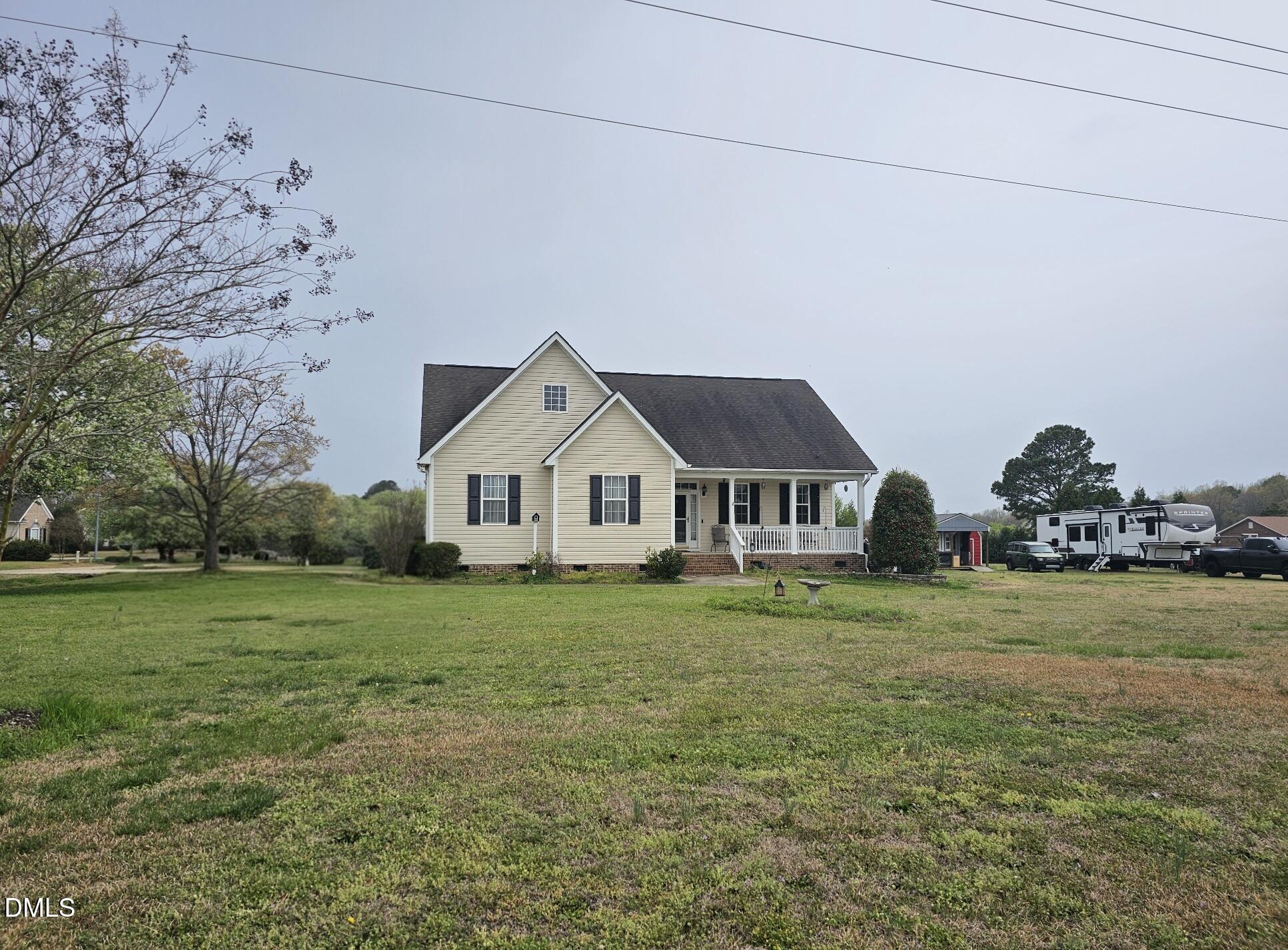 40 Wild Winds Drive Coats, NC 27521 - Photo 24 of 26 a front view of a house with a yard and trees