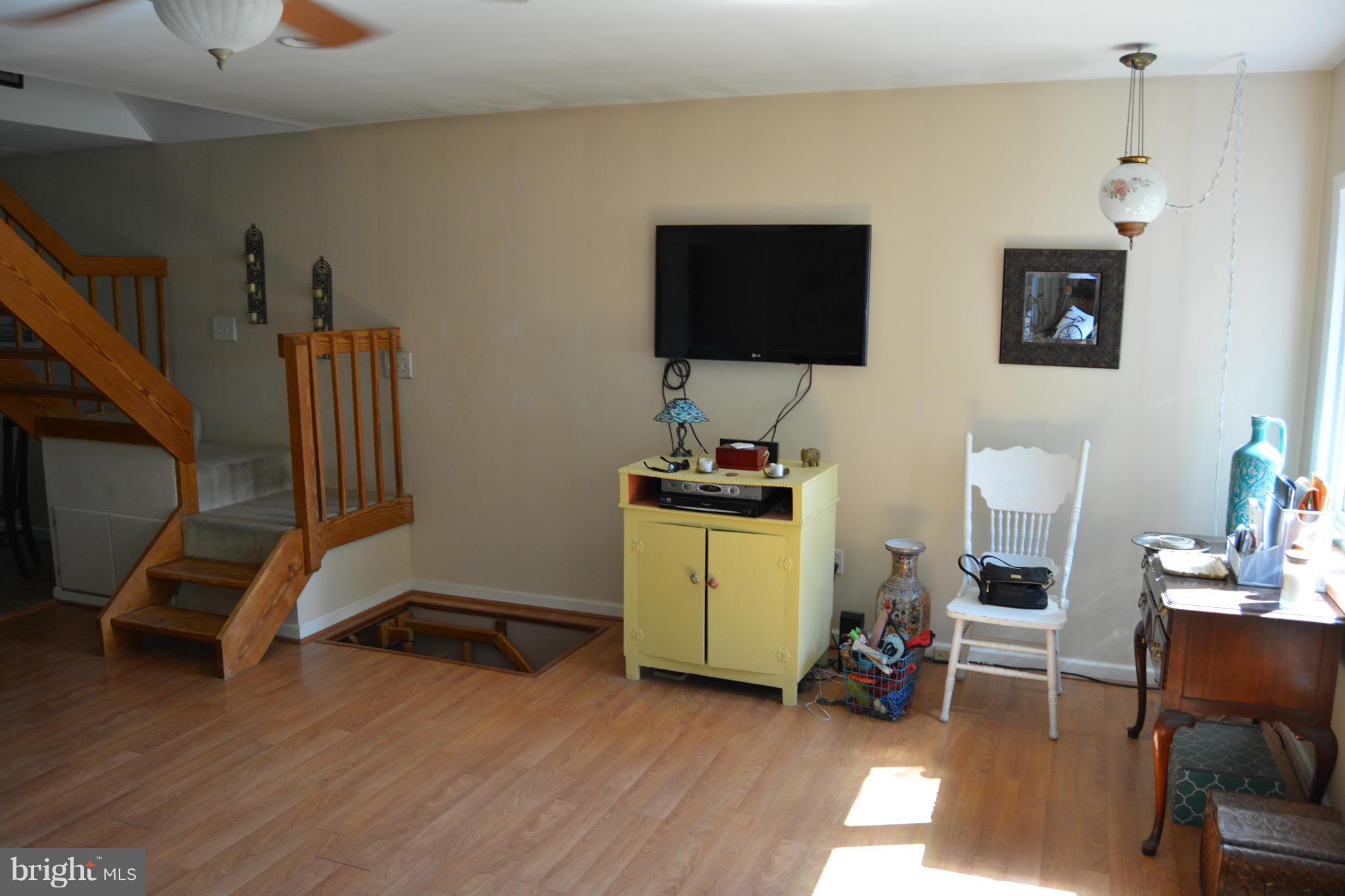 348 Ridge Road Pasadena, MD 21122 - Photo 12 of 27 a view of a workspace with furniture and a flat screen tv