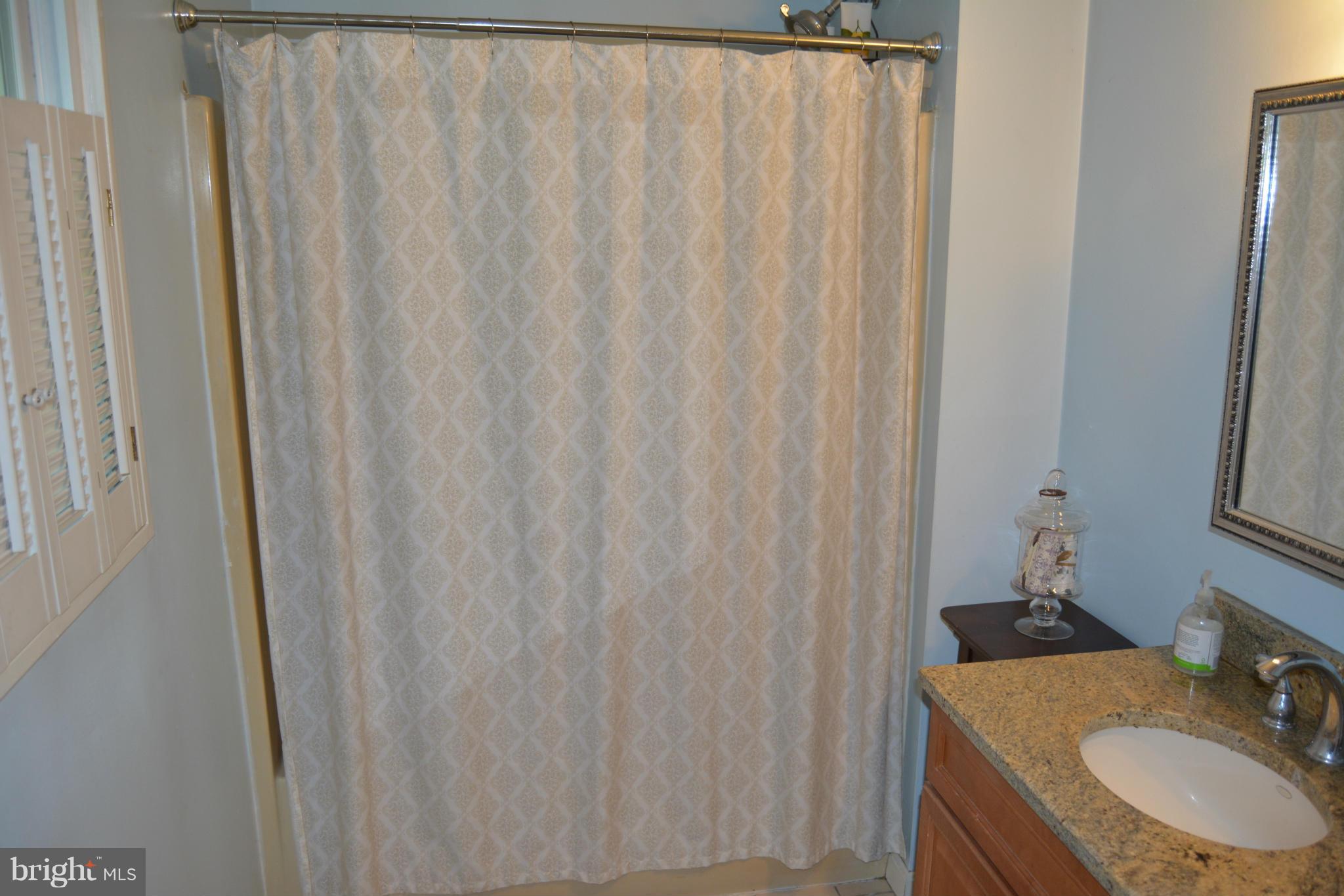 348 Ridge Road Pasadena, MD 21122 - Photo 18 of 27 a bathroom with a sink and curtain