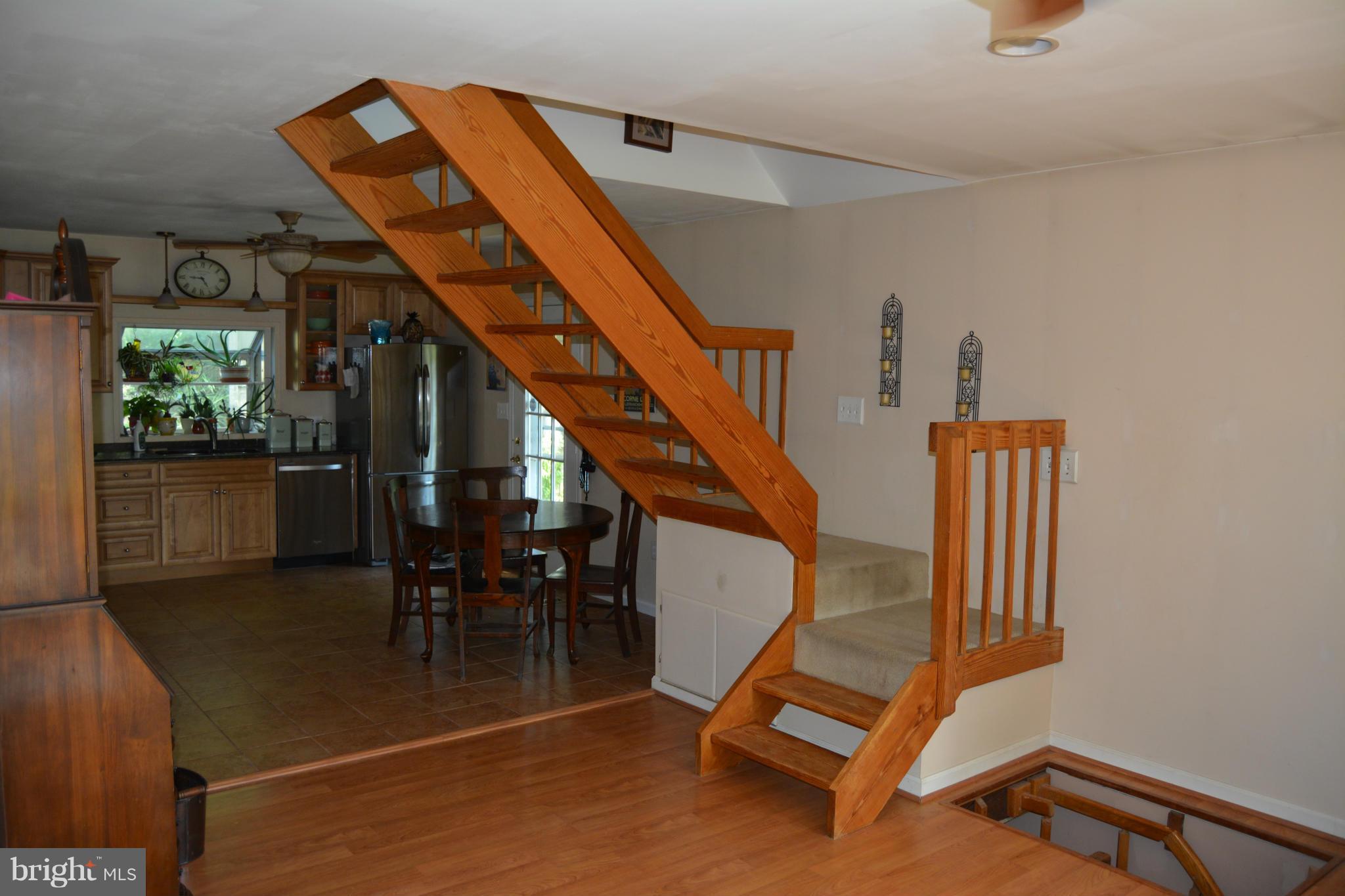 348 Ridge Road Pasadena, MD 21122 - Photo 10 of 27 a view of staircase with furniture and a window