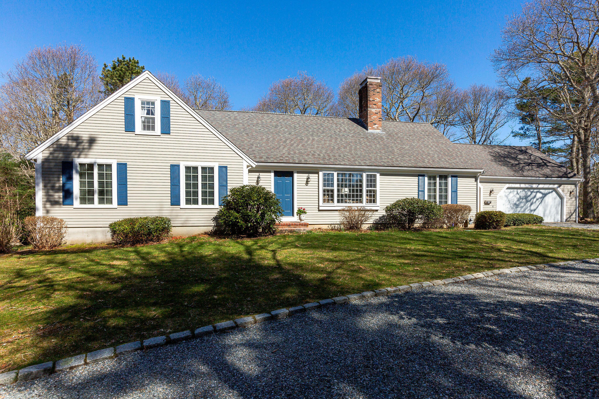 89 Screecham Way Cotuit, MA 02635 - Photo 2 of 50 a front view of a house with a yard