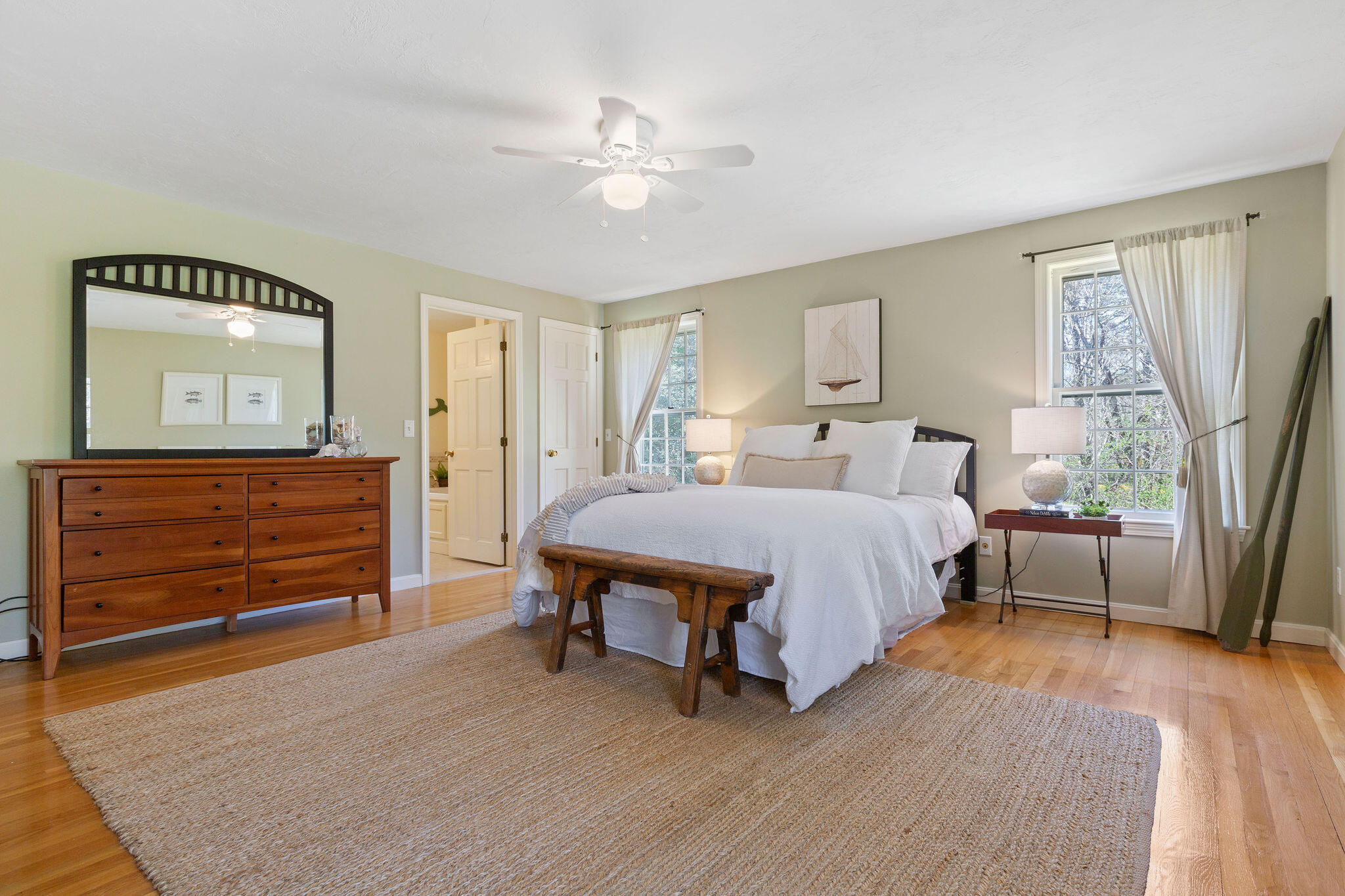 89 Screecham Way Cotuit, MA 02635 - Photo 27 of 50 a spacious bedroom with a bed a dresser and a large window