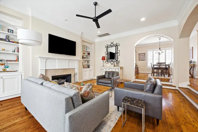 a living room with fireplace furniture and a flat screen tv