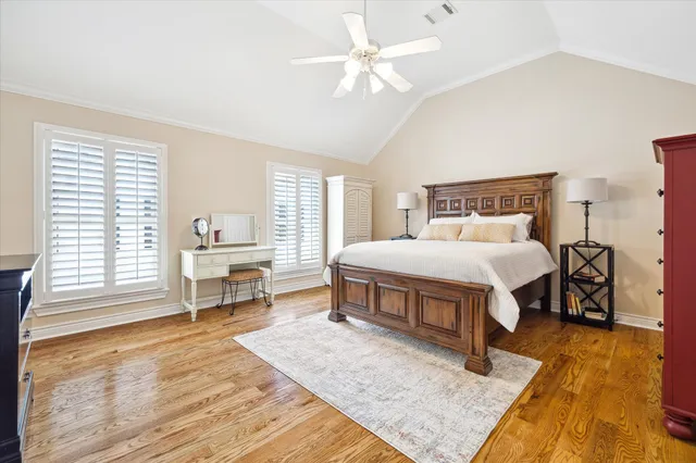 a bedroom with a bed a table and chair