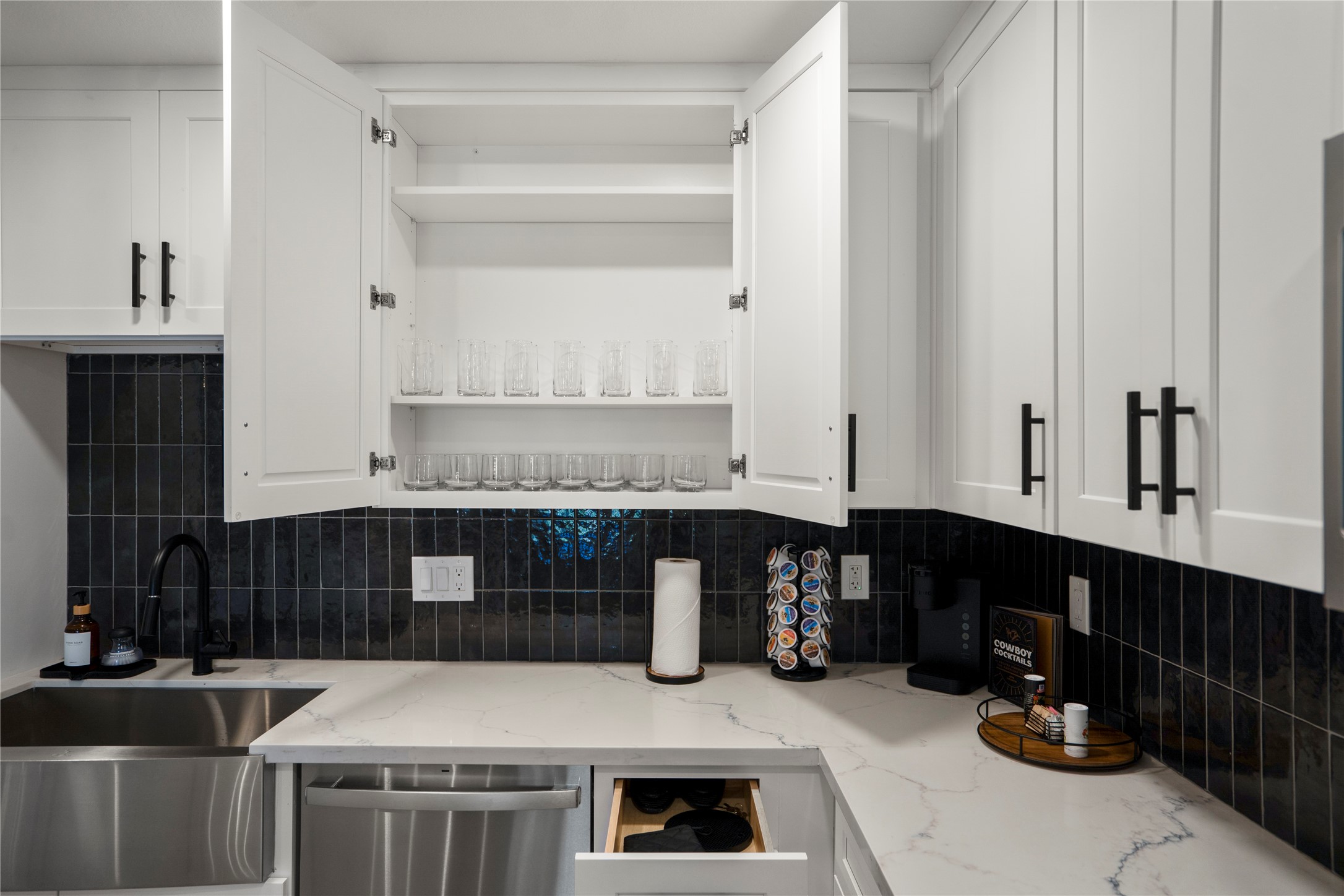 9619 Chatfield Street Houston, TX 77025 - Photo 17 of 44 a kitchen with a sink and cabinets