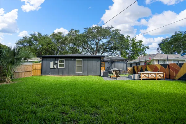 a backyard of a house with table and chairs