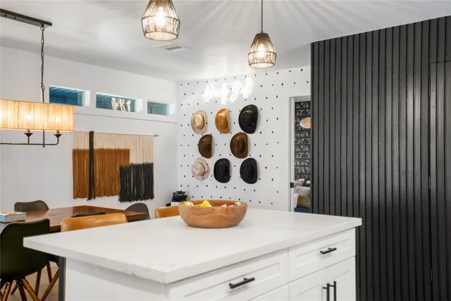 a room with a table and a painting on the wall