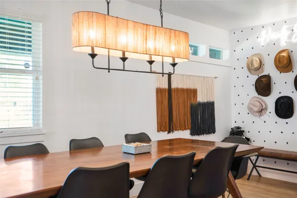 a kitchen with a stove a sink a dining table and chairs