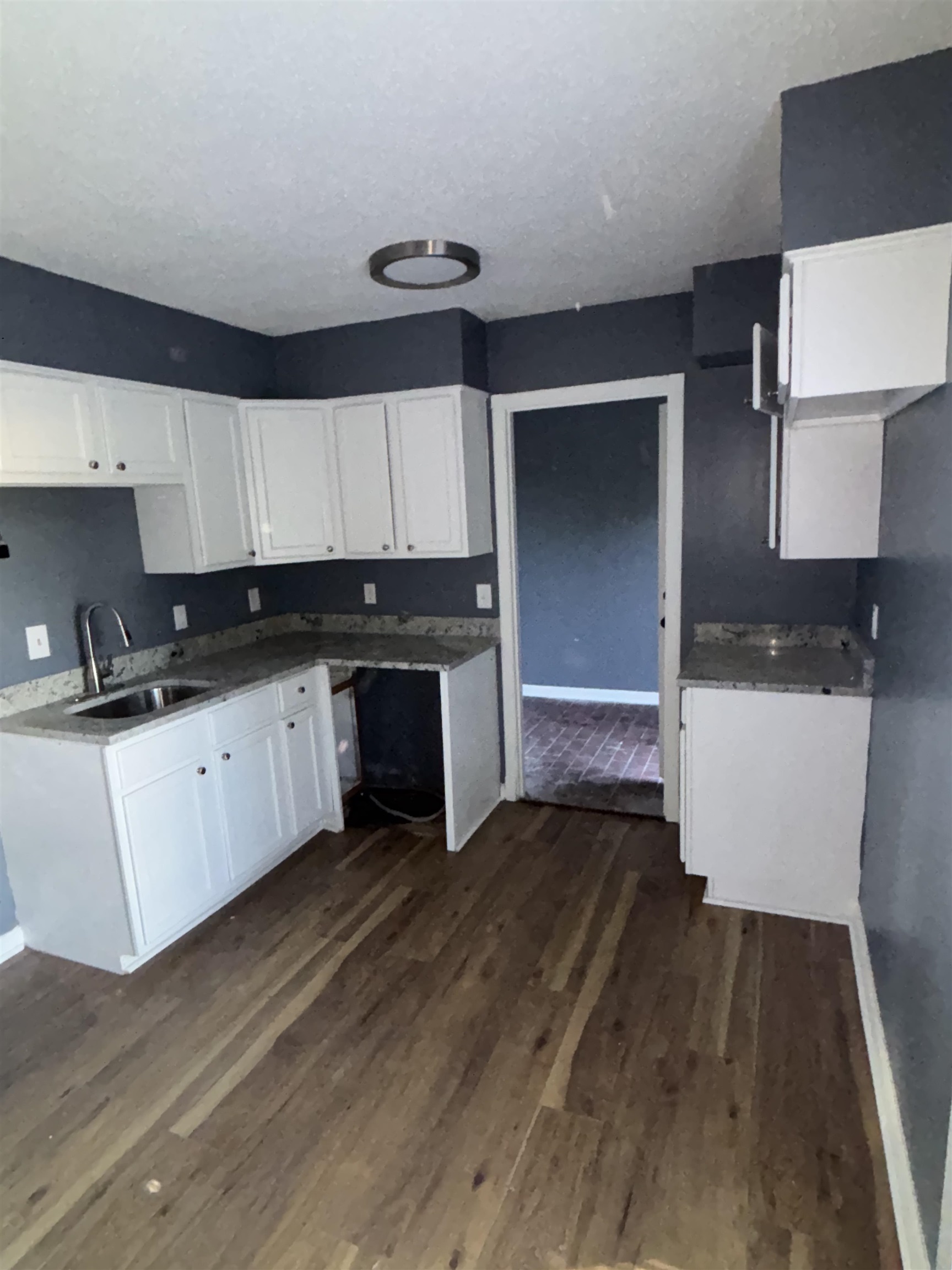 1157 Prescott Road Memphis, TN 38111 - Photo 16 of 31 a kitchen with granite countertop a stove a sink and a refrigerator