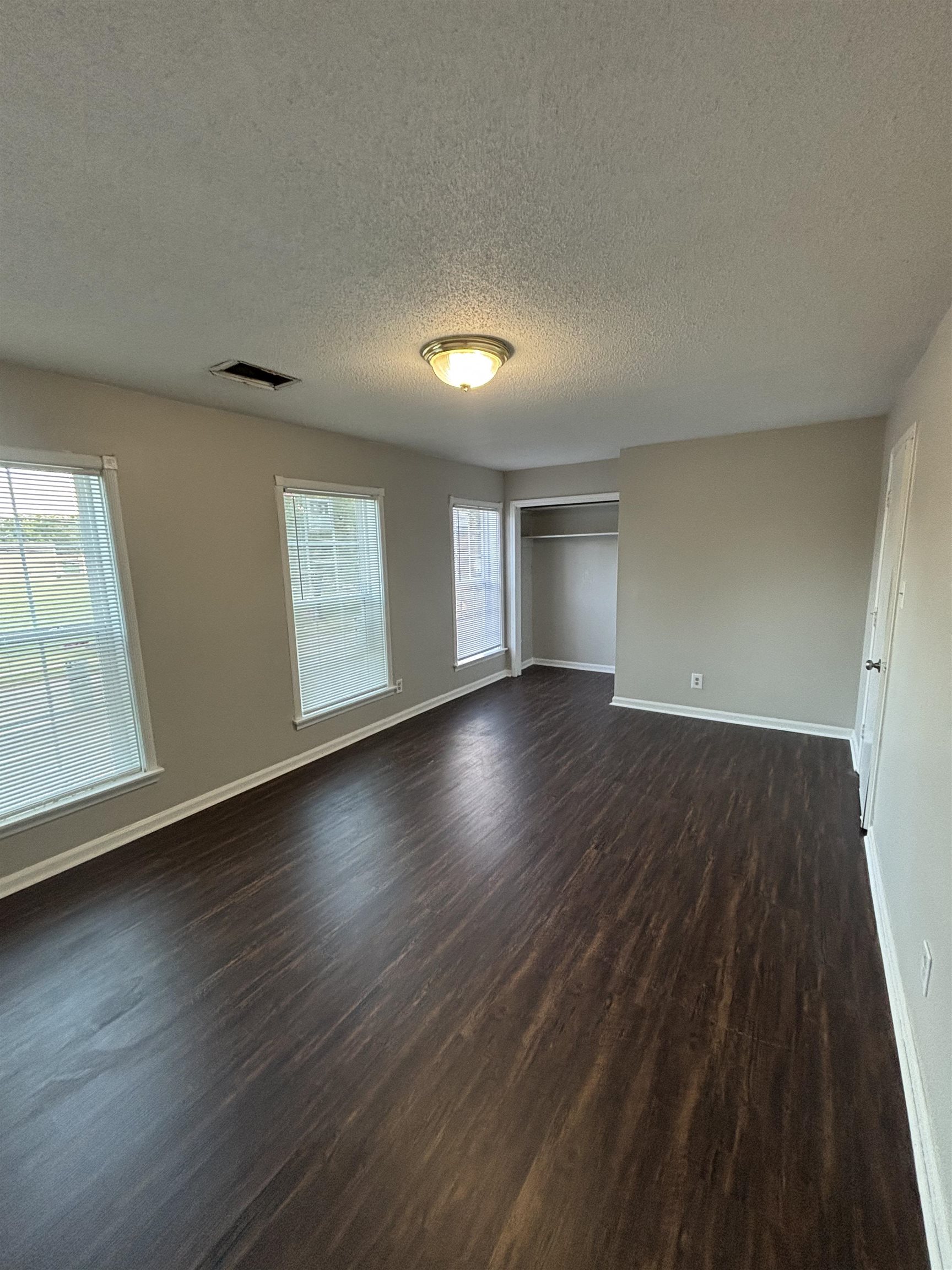 1157 Prescott Road Memphis, TN 38111 - Photo 23 of 31 an empty room with wooden floor and windows