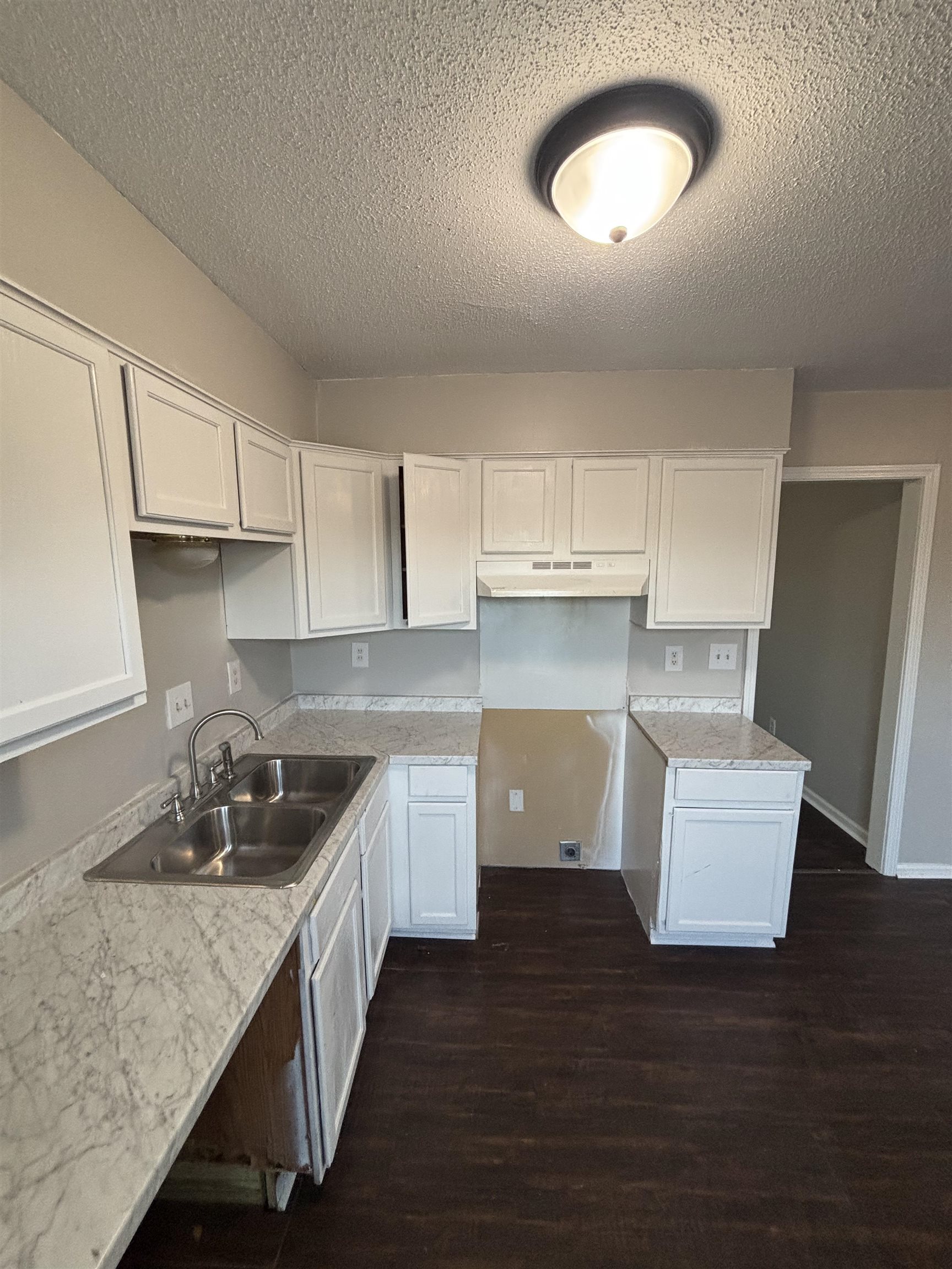 1157 Prescott Road Memphis, TN 38111 - Photo 28 of 31 a kitchen with kitchen island granite countertop a sink and a stove