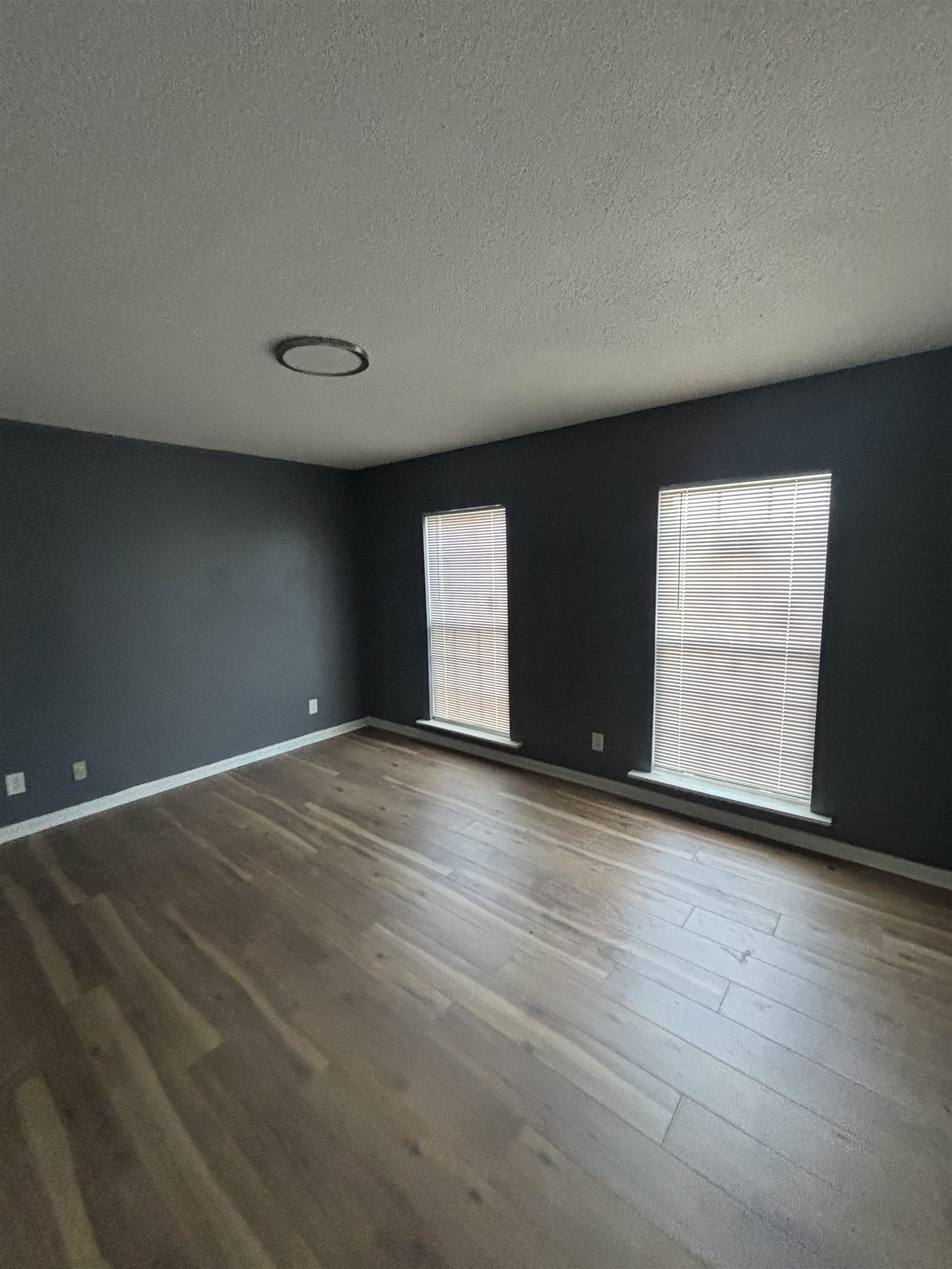 1157 Prescott Road Memphis, TN 38111 - Photo 8 of 31 a view of an empty room with wooden floor and windows