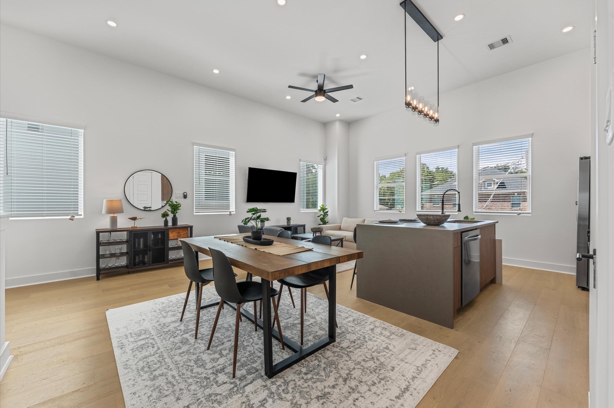 2424 Freeman Street Houston, TX 77009 - Photo 10 of 43 The dining area, part of the open-concept living, dining, and kitchen on the second floor, offers ample space for a large table, making it perfect for family meals or entertaining friends, while seamlessly flowing with the bright, airy atmosphere of the surrounding living space.