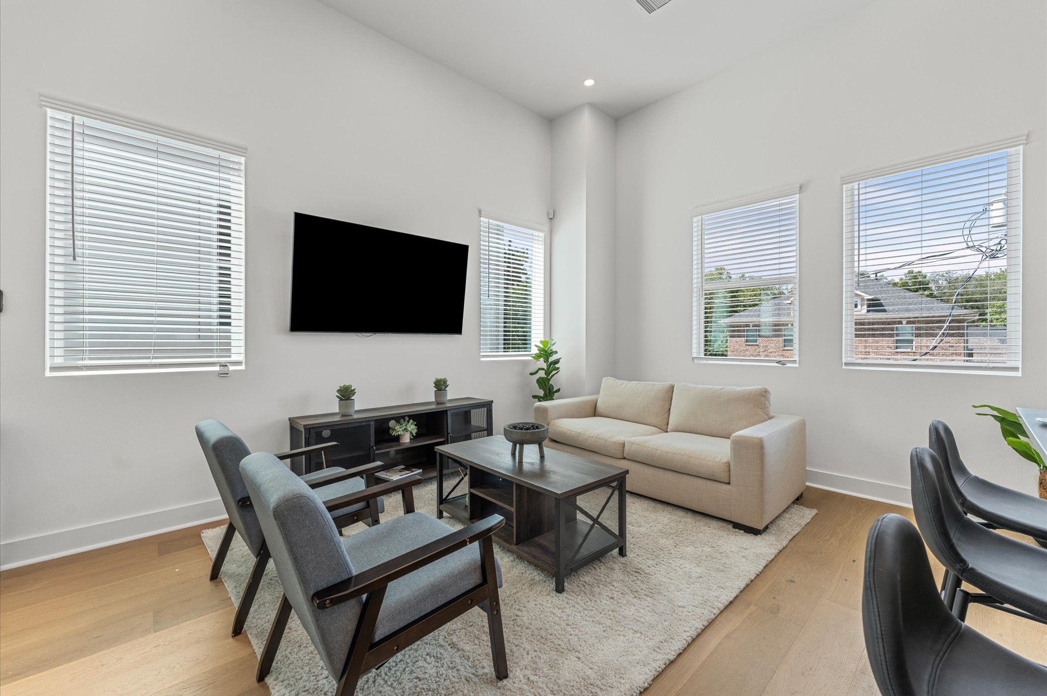 2424 Freeman Street Houston, TX 77009 - Photo 11 of 43 The living area, part of a bright open-concept living, dining, and kitchen on the second floor, offers plenty of space while maintaining its own personality, surrounded by windows that fill the room with natural light and create a welcoming, airy atmosphere perfect for relaxing or entertaining.