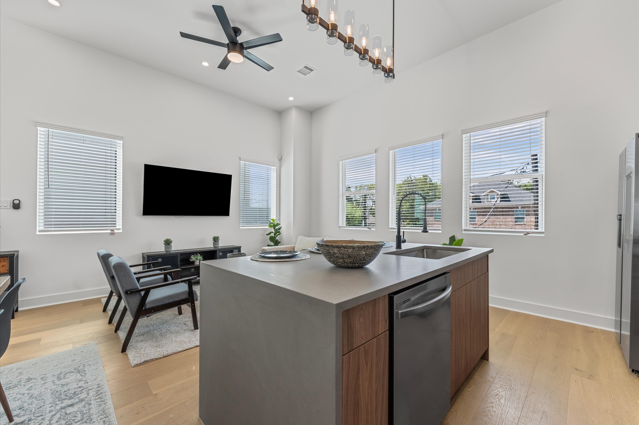 2424 Freeman Street Houston, TX 77009 - Photo 16 of 43 The heart of the second-floor open-concept living, dining, and kitchen, this spacious kitchen island features sleek modern finishes, including a one-sided cascade quartz countertop, a farmhouse sink, and stylish pendant lighting, with a built-in seating area perfect for casual breakfasts or chatting with family and friends.