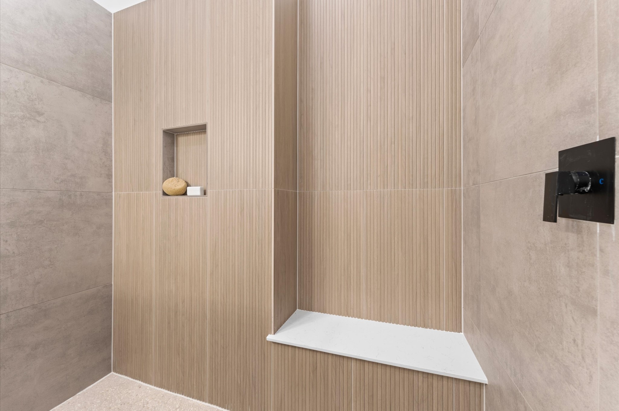 2424 Freeman Street Houston, TX 77009 - Photo 25 of 43 The luxurious primary ensuite features sleek modern finishes, a glass-enclosed shower with stylish tile, and a double-sink vanity topped with quartz countertops, complemented by two contemporary mirrors and lighting fixtures, creating a bright, elegant, and functional retreat.