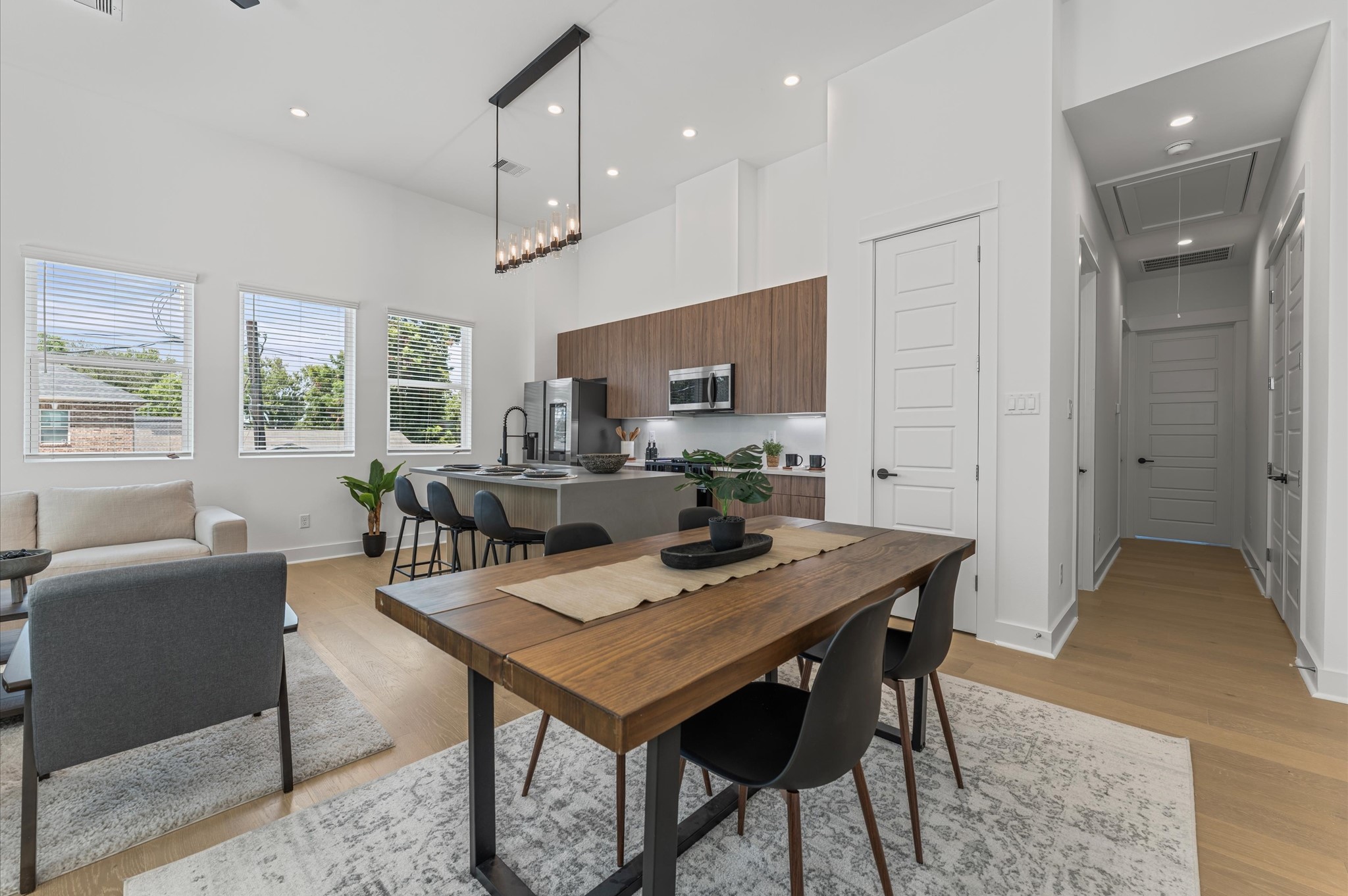 2424 Freeman Street Houston, TX 77009 - Photo 9 of 43 The dining area, part of the open-concept living, dining, and kitchen on the second floor, offers ample space for a large table, making it perfect for family meals or entertaining friends, while seamlessly flowing with the bright, airy atmosphere of the surrounding living space.