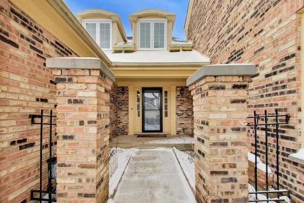 a view of a door with brick walls