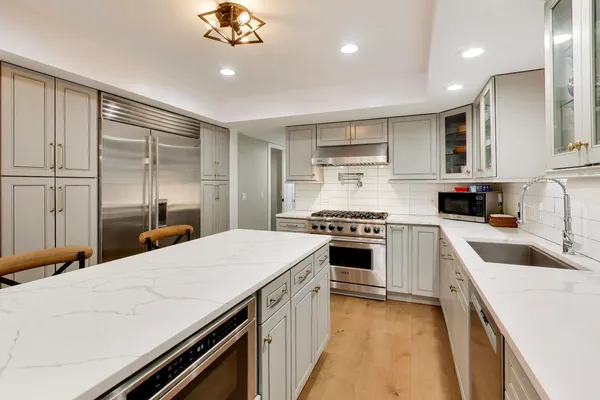 a kitchen with a stove sink and cabinets