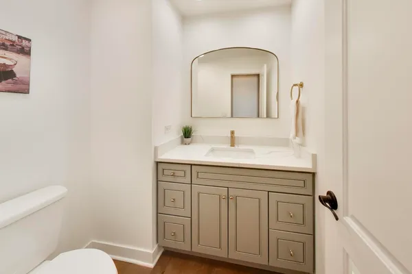 a bathroom with a toilet sink and mirror