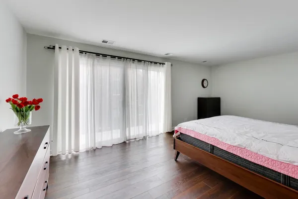 a bedroom with a bed and a potted plant