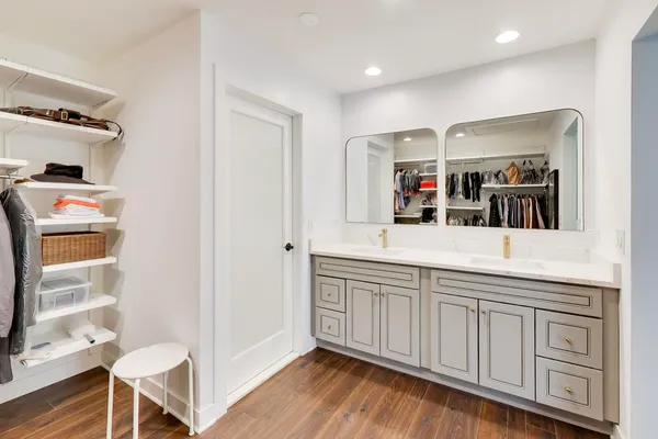 a spacious bathroom with a sink and a mirror