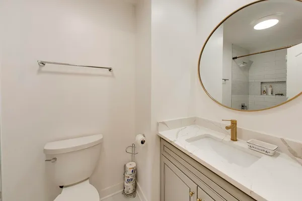 a bathroom with a sink toilet and mirror