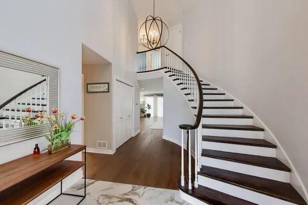 a view of entryway and hall with wooden floor